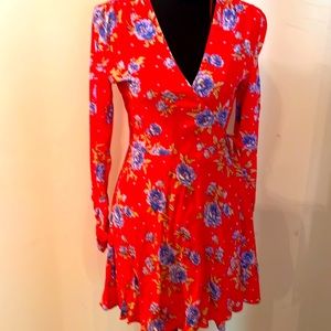 Zara wrapped dress in orange with purple flowers.